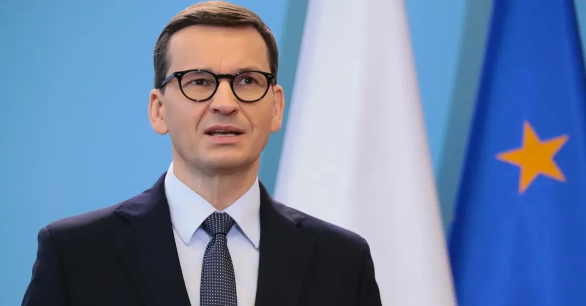 Mateusz Morawiecki na tle flagi Polski i UE