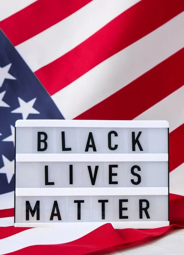 Napis "Black Lives Matter" na tle amerykańskiej flagi