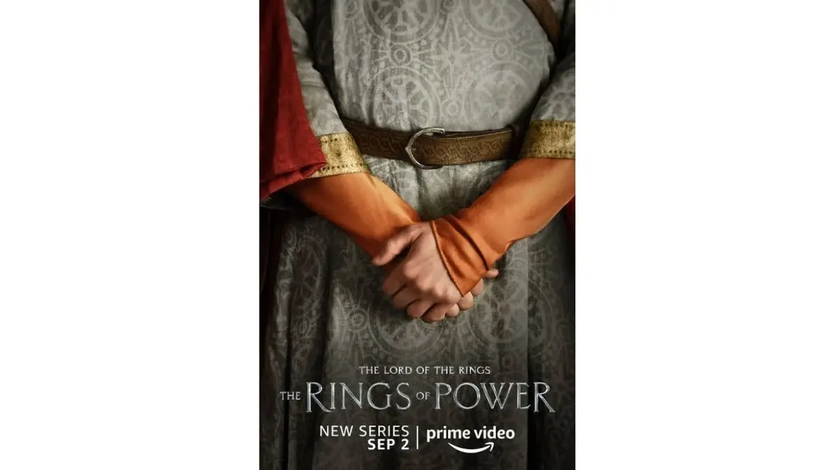 Plakat "Pierścienie władzy": dłonie w pomarańczowych rękawach