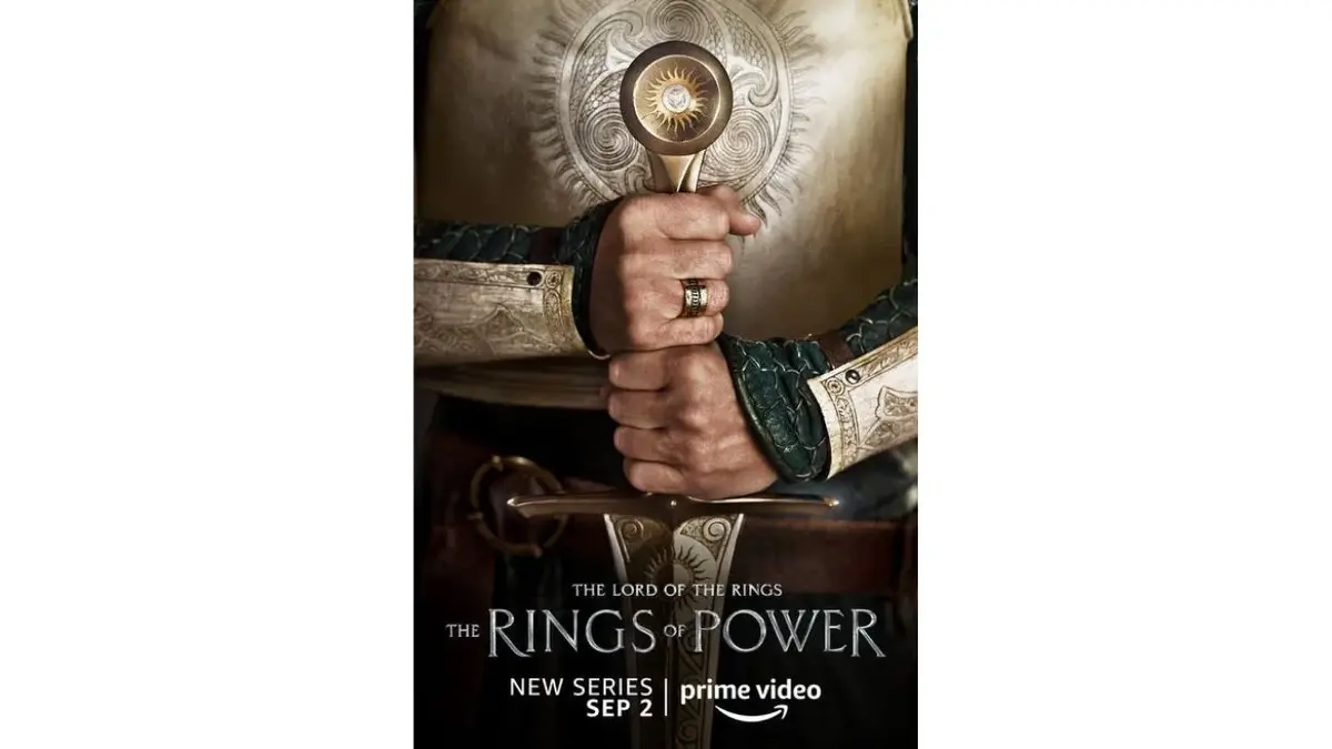 Plakat "Pierścienie władzy": dłonie z mieczem ozdobionym słońcem