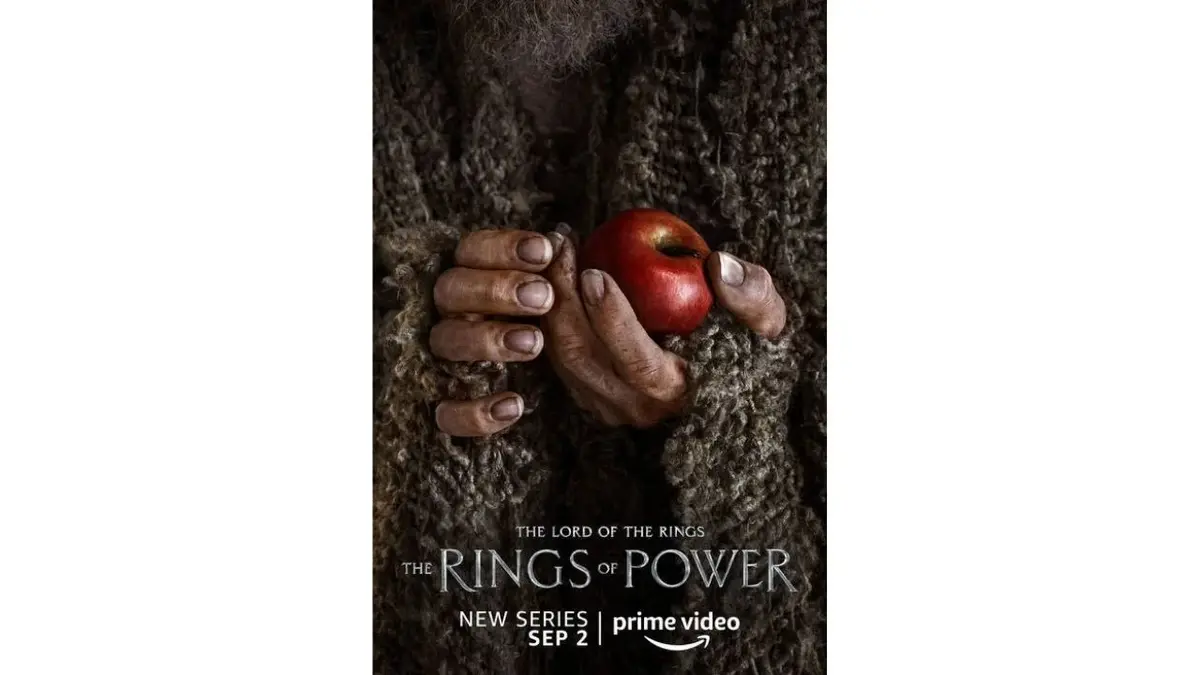 Plakat "Pierścienie władzy": dłonie z czerwonym jabłkiem